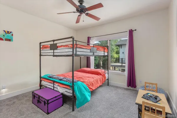 a bedroom with bed and a chandelier