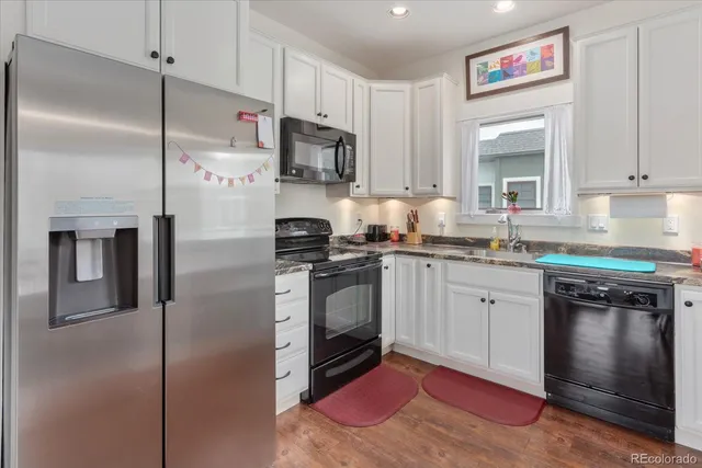 a view of a dining room with furniture a chandelier and wooden floor