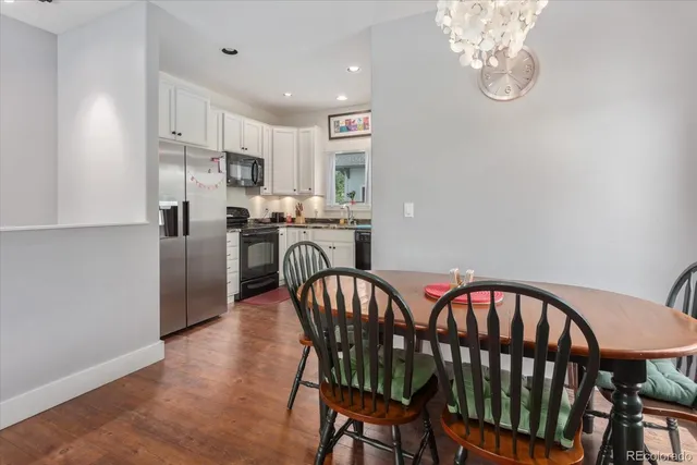 a living room with furniture wooden floor and dining table