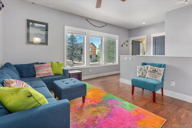 a living room with furniture a table and a chandelier