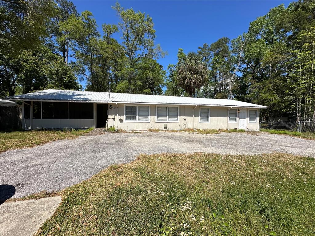 24047 Ermine Road Astor, FL 32102 - Photo 1 of 1 a view of house with trees in the background