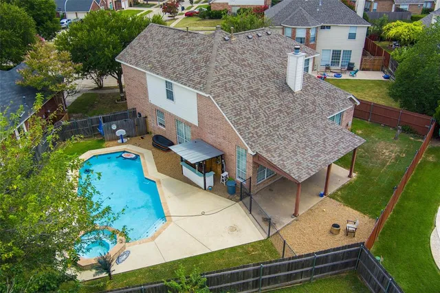 an aerial view of a house with a yard basket ball court and outdoor seating