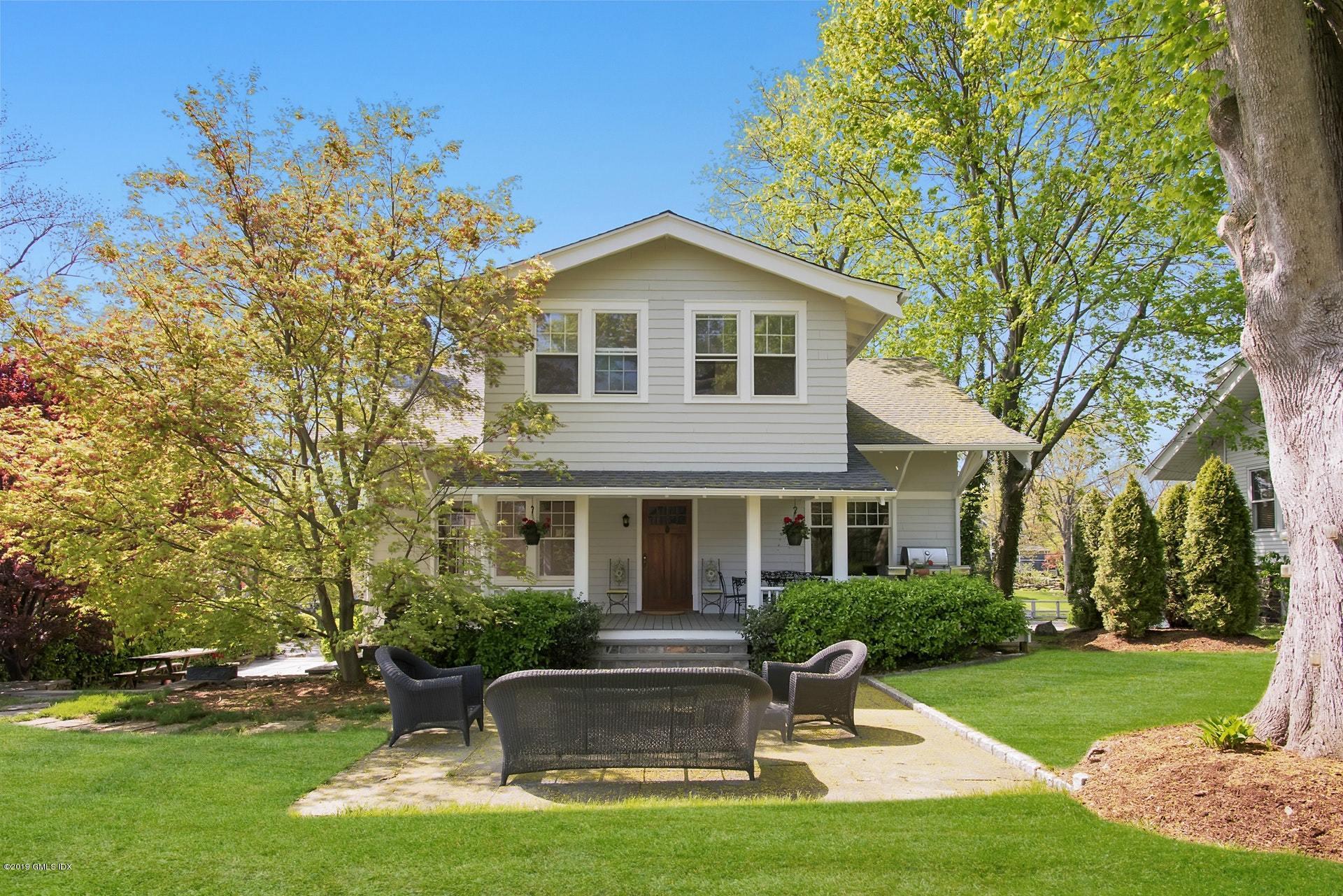 a front view of house with yard and green space