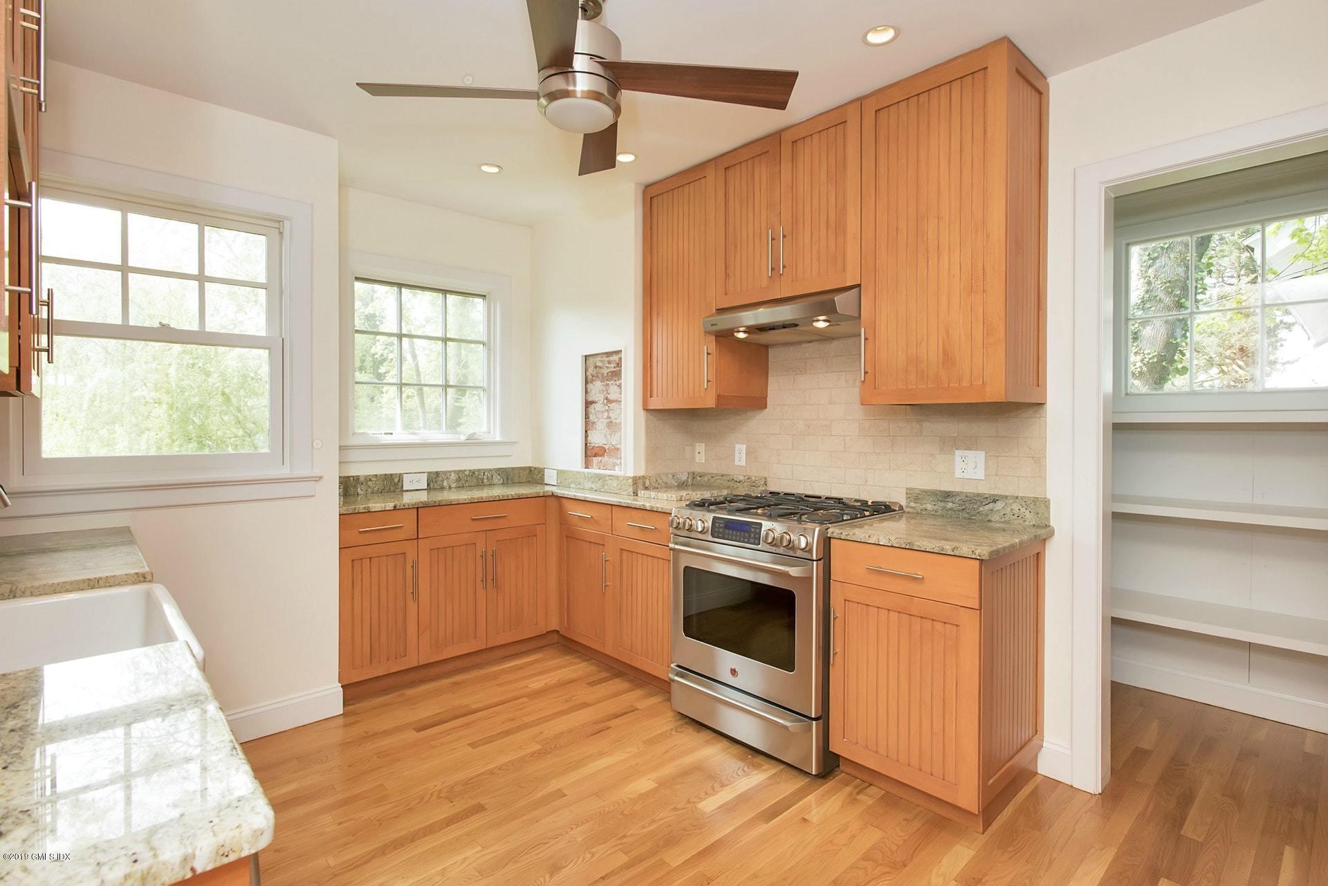 17 Ballwood Road Old Greenwich, CT 06870 - Photo 11 of 36 a kitchen with stainless steel appliances granite countertop a stove a sink and a microwave