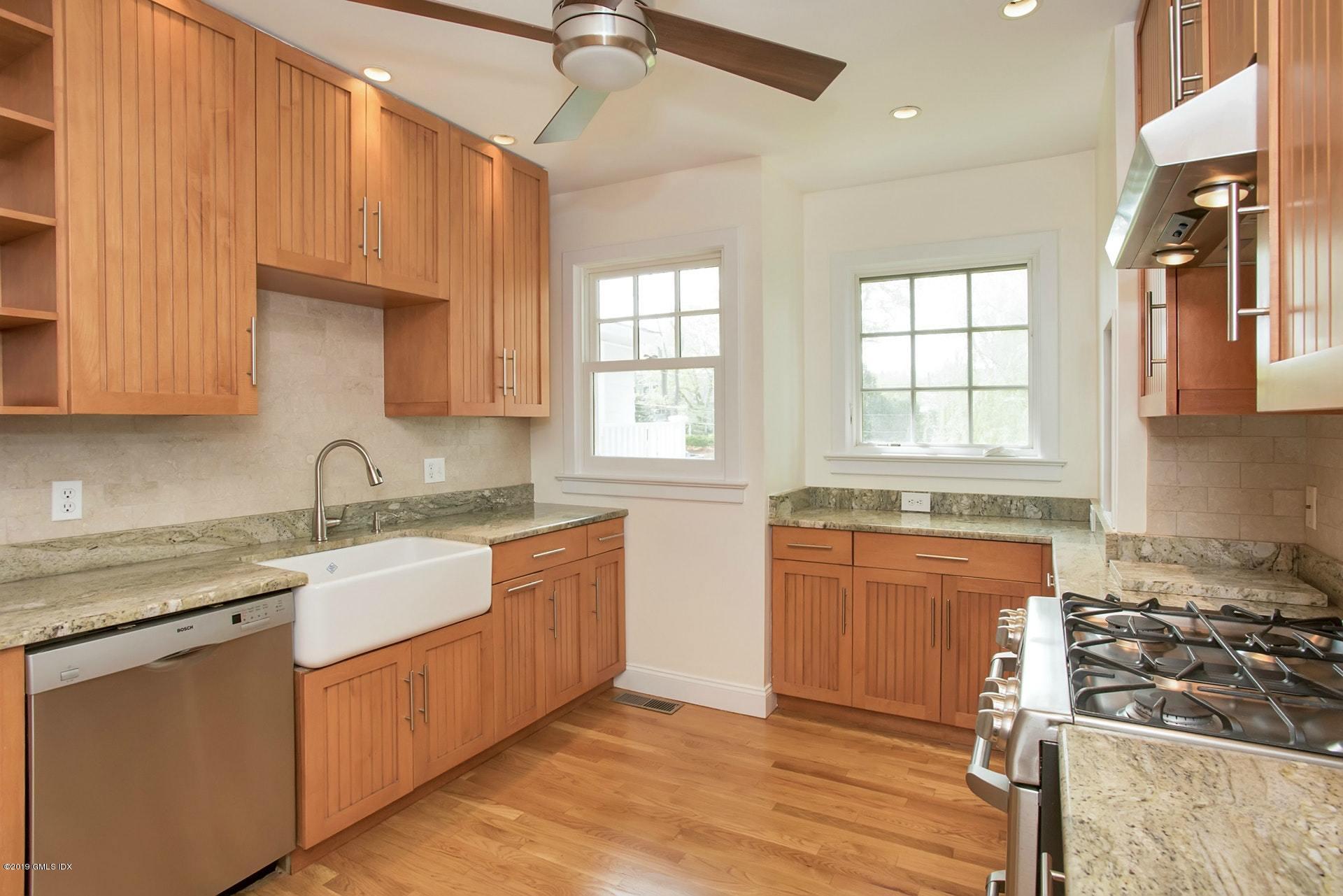 17 Ballwood Road Old Greenwich, CT 06870 - Photo 12 of 36 a kitchen with stainless steel appliances granite countertop a sink stove and refrigerator