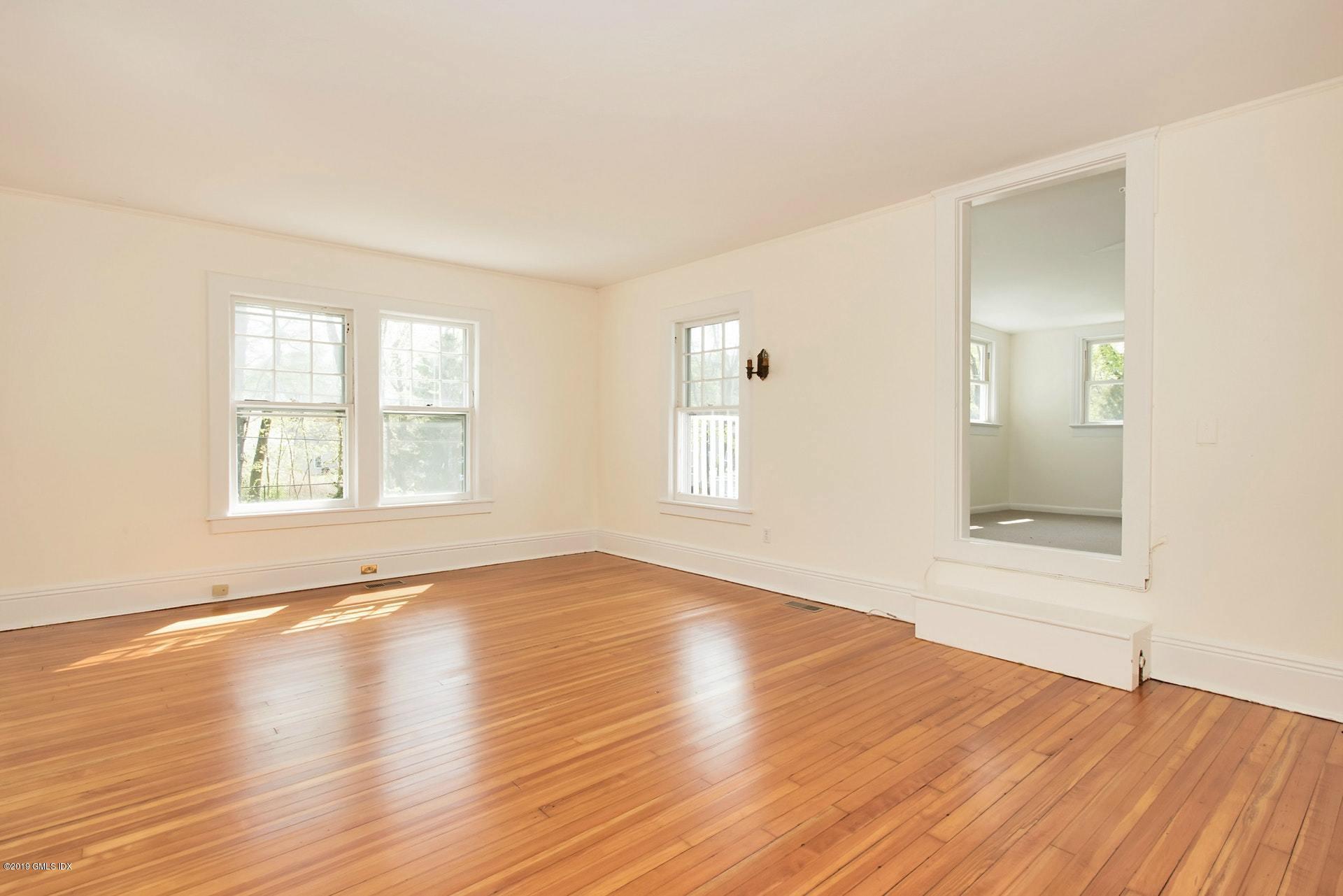 17 Ballwood Road Old Greenwich, CT 06870 - Photo 15 of 36 an empty room with wooden floor and windows
