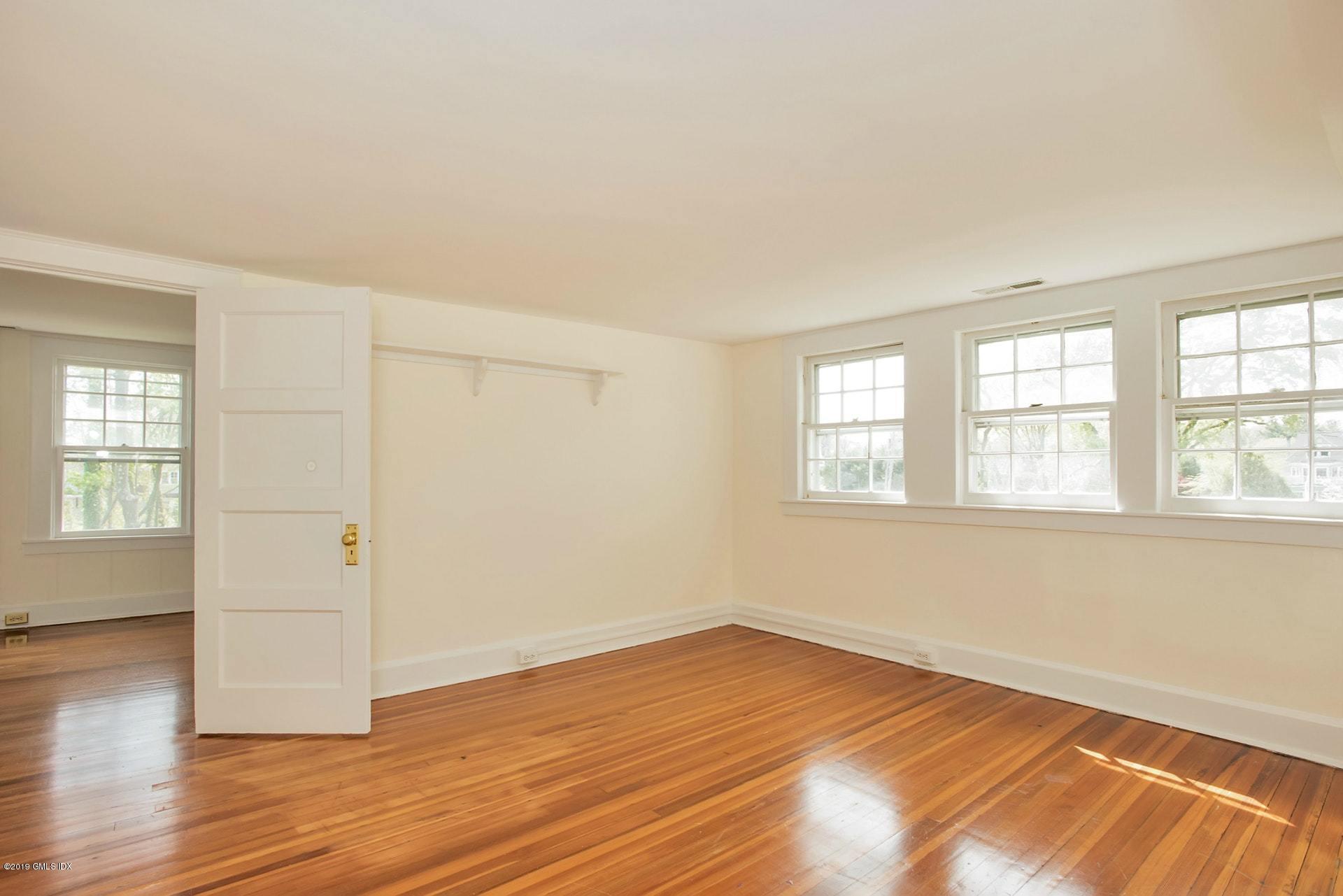 17 Ballwood Road Old Greenwich, CT 06870 - Photo 20 of 36 an empty room with wooden floor and windows