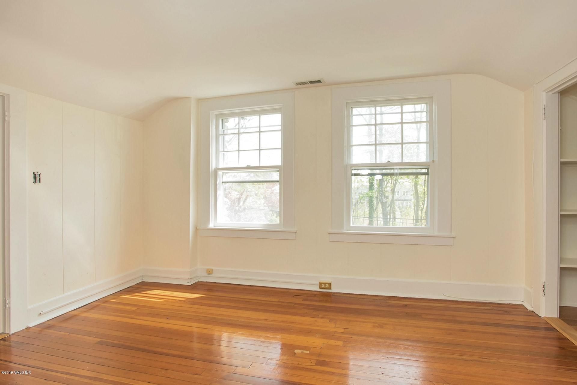 17 Ballwood Road Old Greenwich, CT 06870 - Photo 22 of 36 an empty room with wooden floor and windows