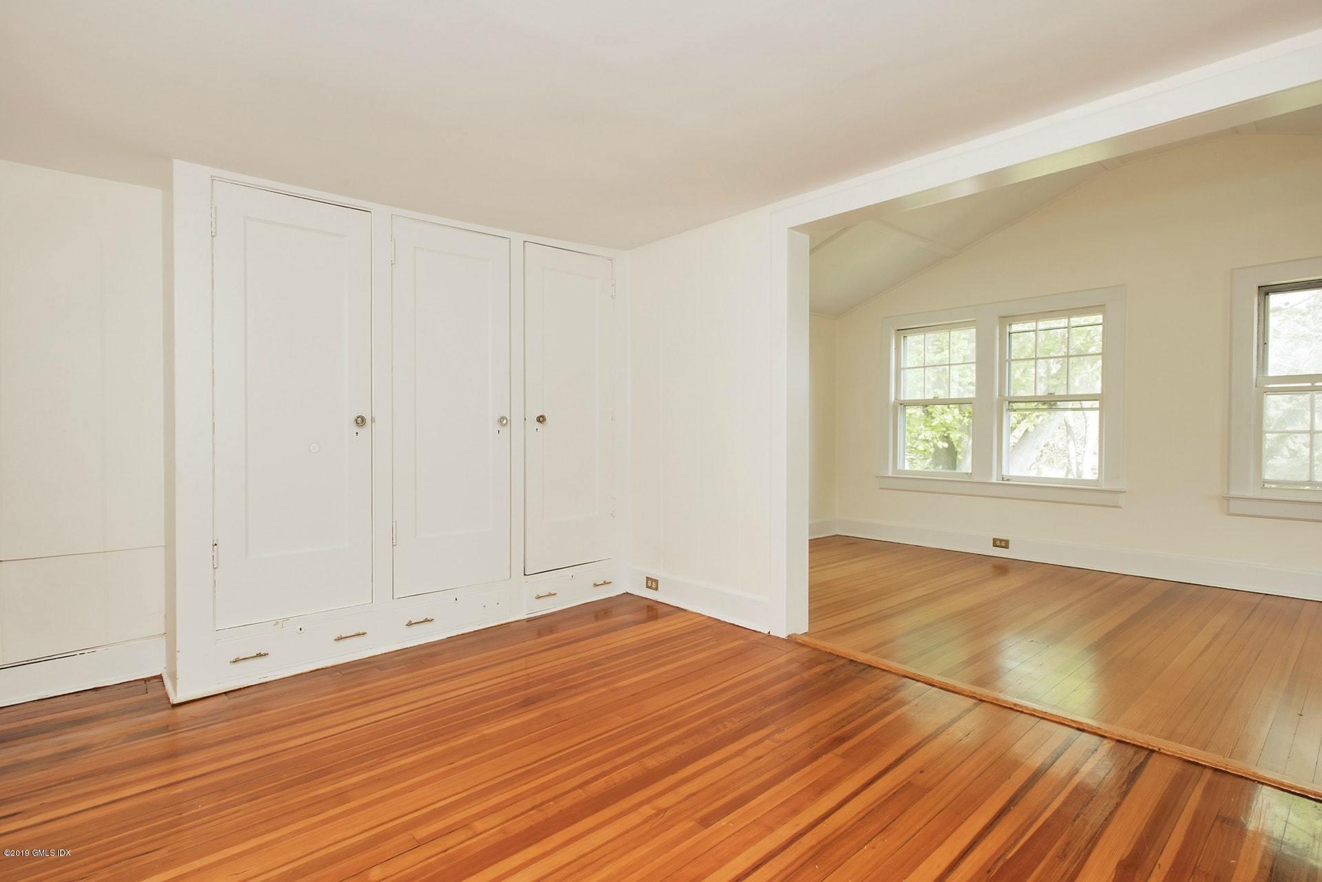 17 Ballwood Road Old Greenwich, CT 06870 - Photo 25 of 36 an empty room with wooden floor and windows