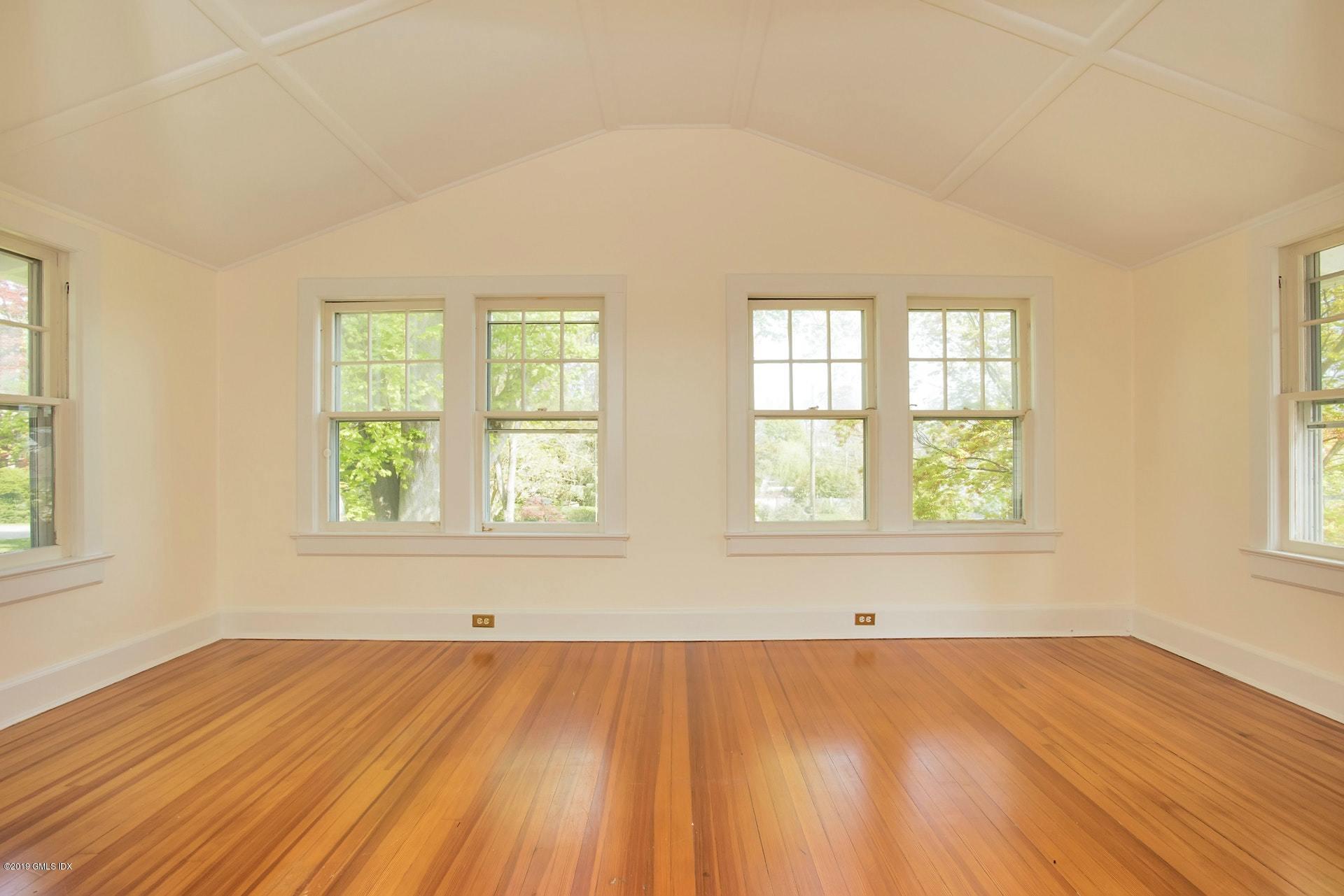 17 Ballwood Road Old Greenwich, CT 06870 - Photo 26 of 36 an empty room with wooden floor and windows