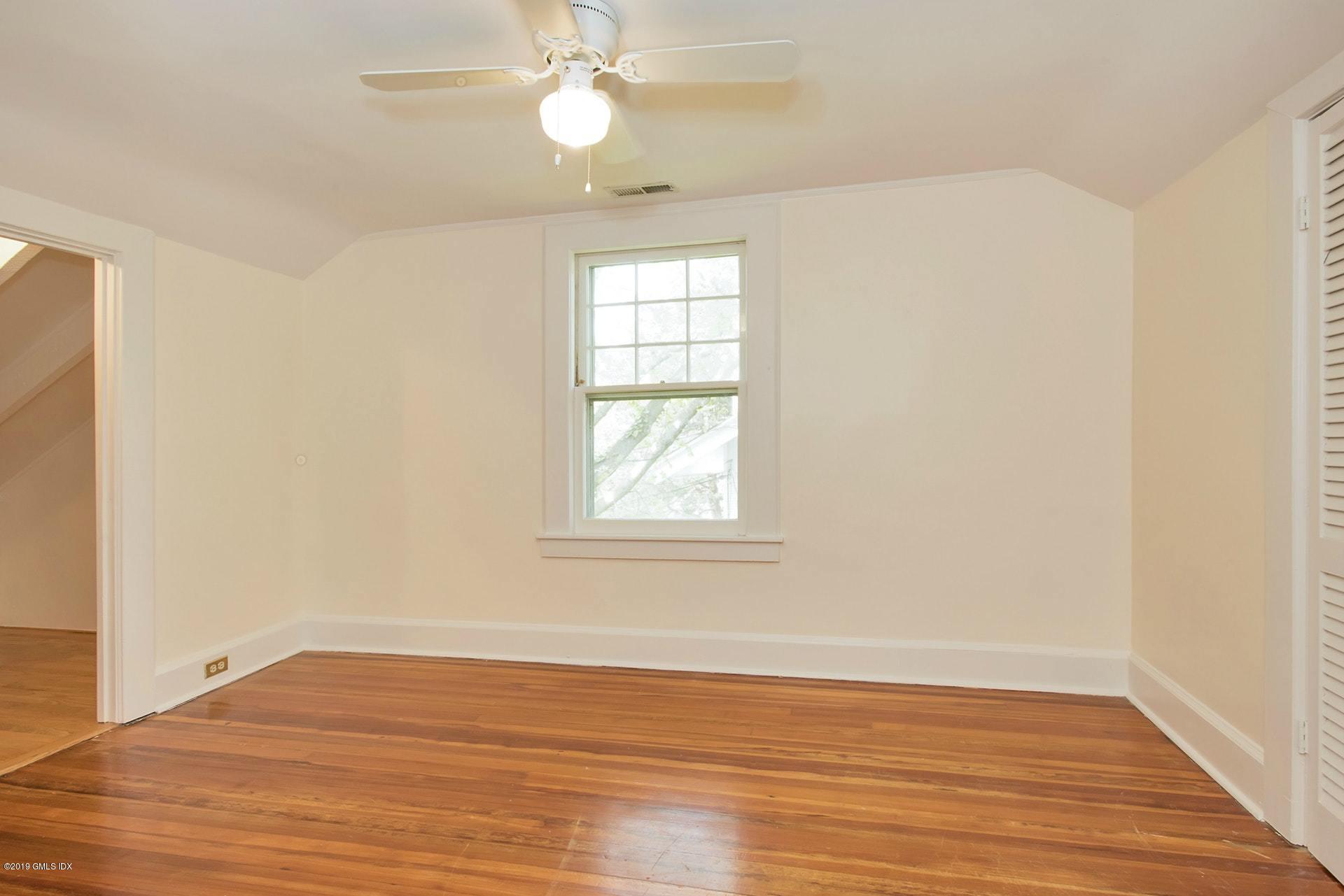 17 Ballwood Road Old Greenwich, CT 06870 - Photo 27 of 36 a view of an empty room with wooden floor and a window