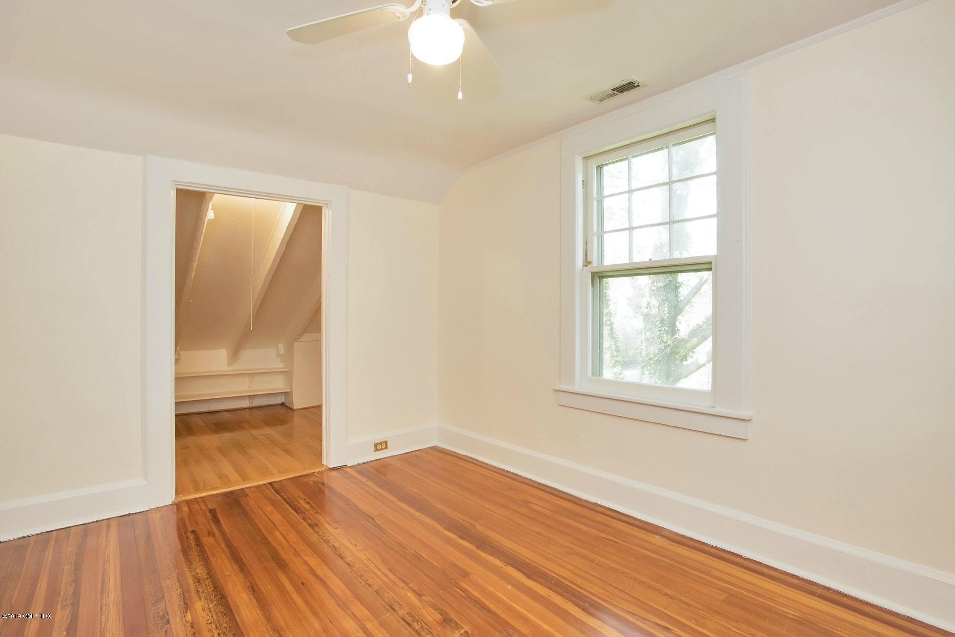 17 Ballwood Road Old Greenwich, CT 06870 - Photo 28 of 36 an empty room with wooden floor and windows