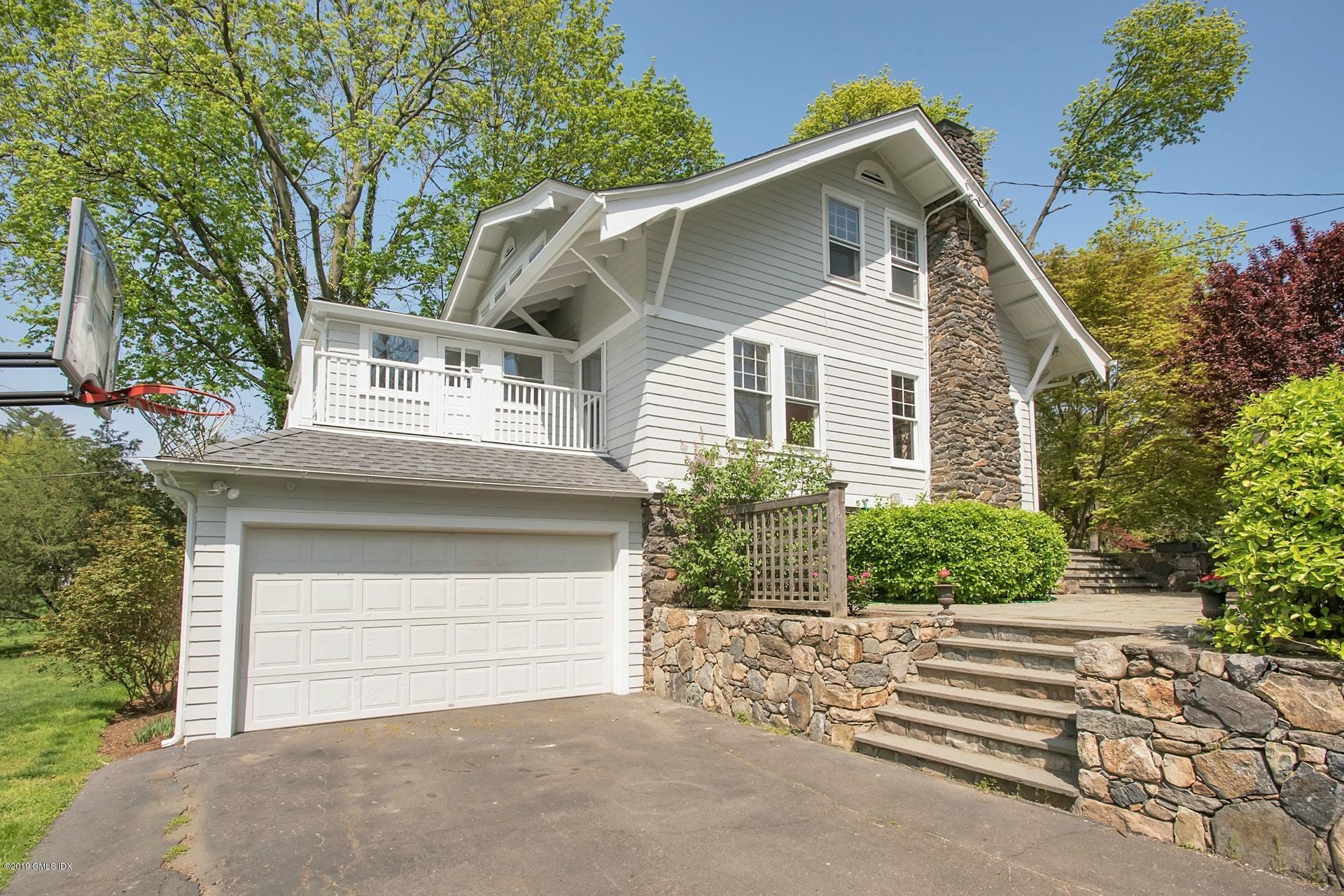 17 Ballwood Road Old Greenwich, CT 06870 - Photo 33 of 36 a front view of a house with a yard and garage