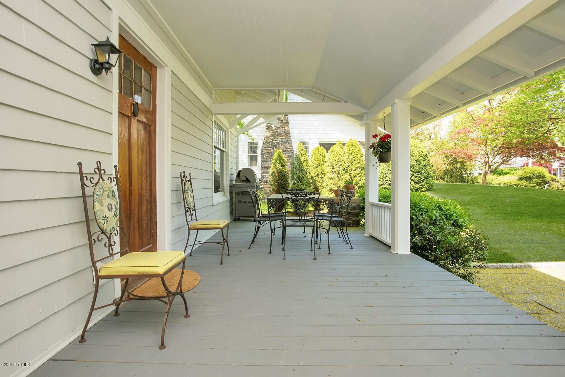 17 Ballwood Road Old Greenwich, CT 06870 - Photo 4 of 36 a view of a patio with a table chairs and a garden