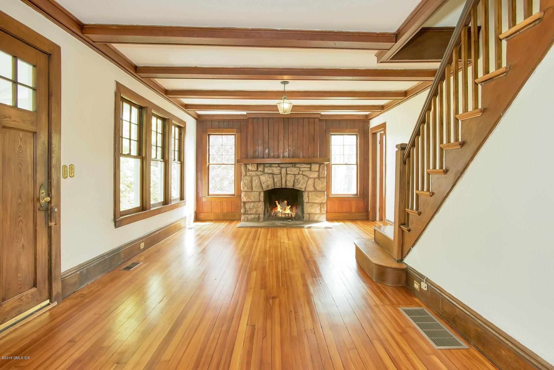 17 Ballwood Road Old Greenwich, CT 06870 - Photo 7 of 36 a view of an empty room with wooden floor fireplace and a window