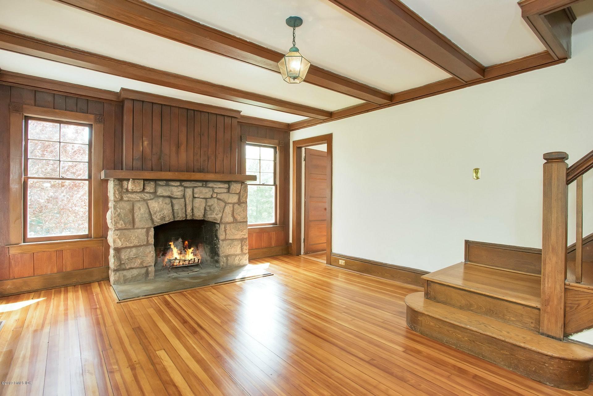 17 Ballwood Road Old Greenwich, CT 06870 - Photo 8 of 36 a view of an empty room with wooden floor fireplace and a window