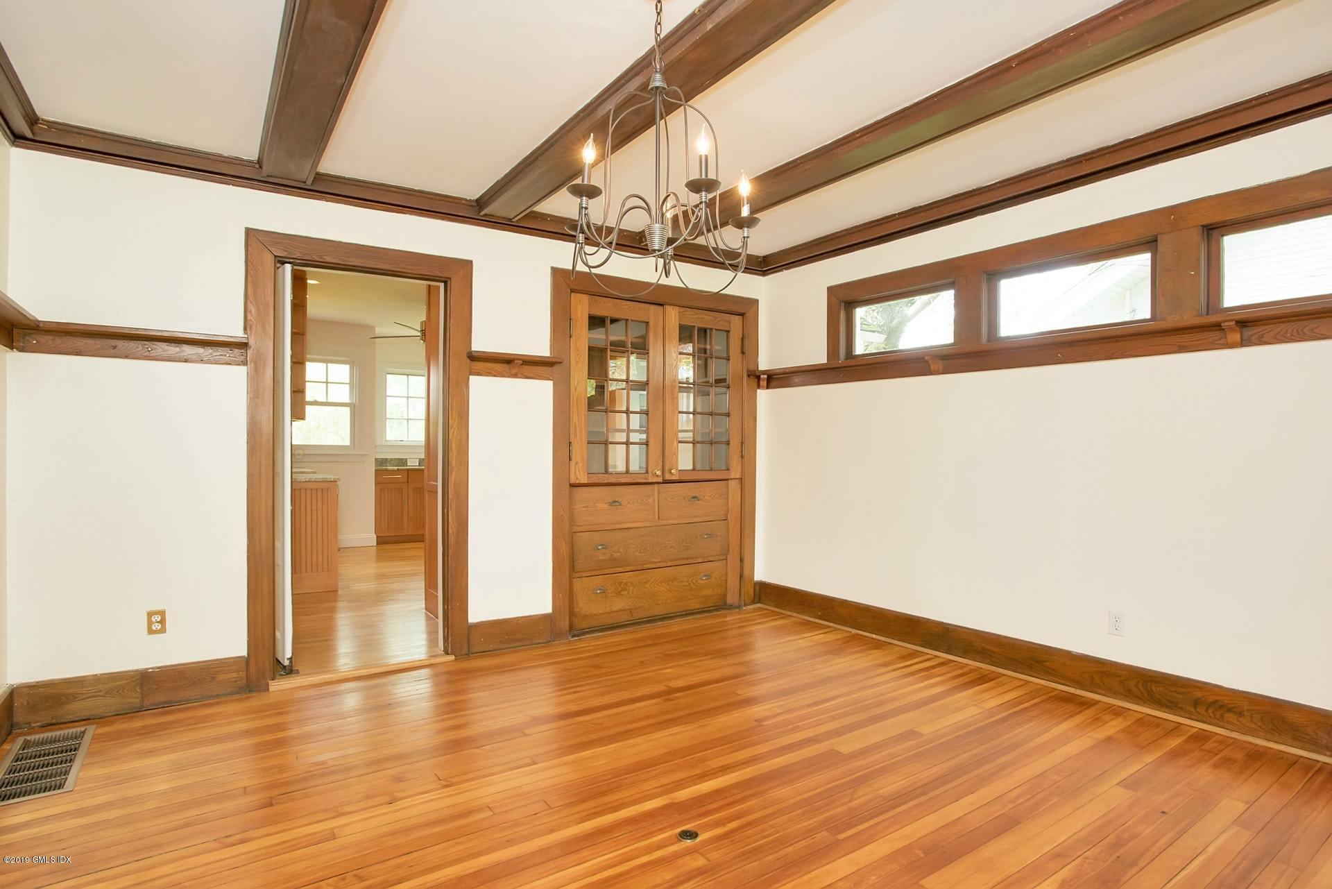 17 Ballwood Road Old Greenwich, CT 06870 - Photo 10 of 36 a view of an empty room with wooden floor and windows
