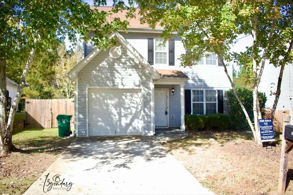 7050 Setters Way Lithonia, GA 30038 - Photo 1 of 1 a view of a brick house with a yard and large tree