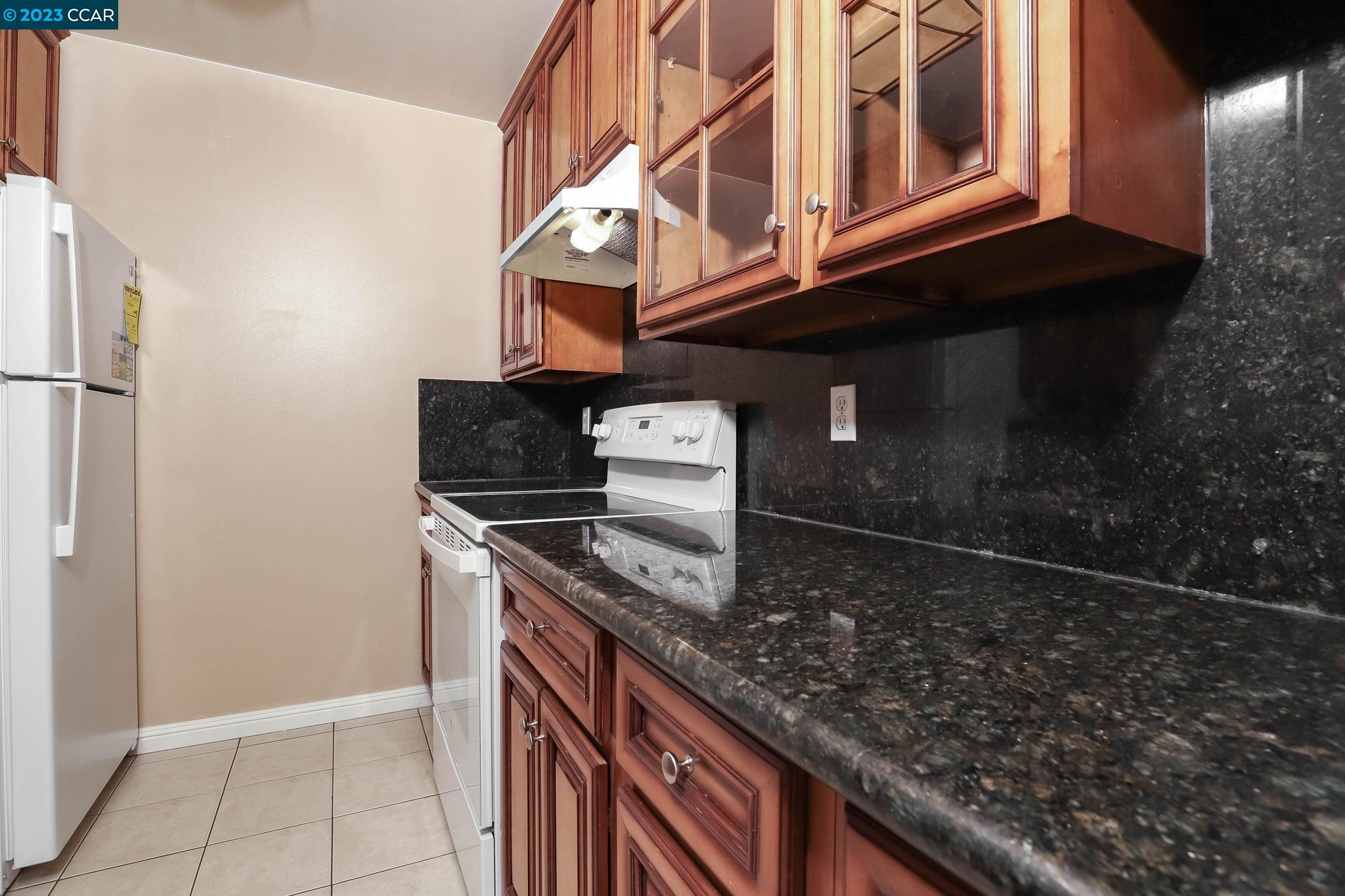 2500 Laguna Circle, Unit C Concord, CA 94520 - Photo 4 of 13 a kitchen with granite countertop a sink and a stove