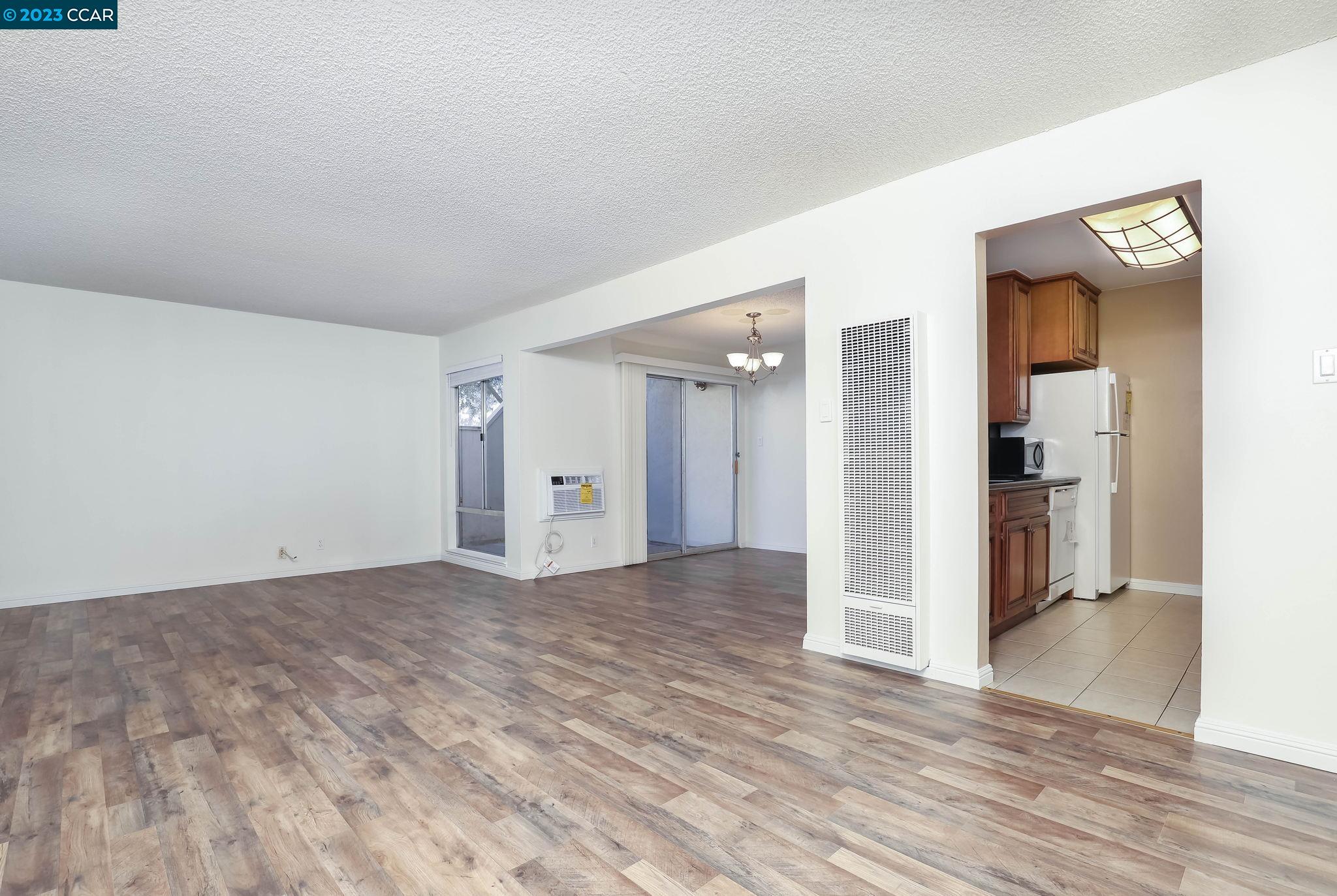 2500 Laguna Circle, Unit C Concord, CA 94520 - Photo 5 of 13 a view of a livingroom with wooden floor and closet