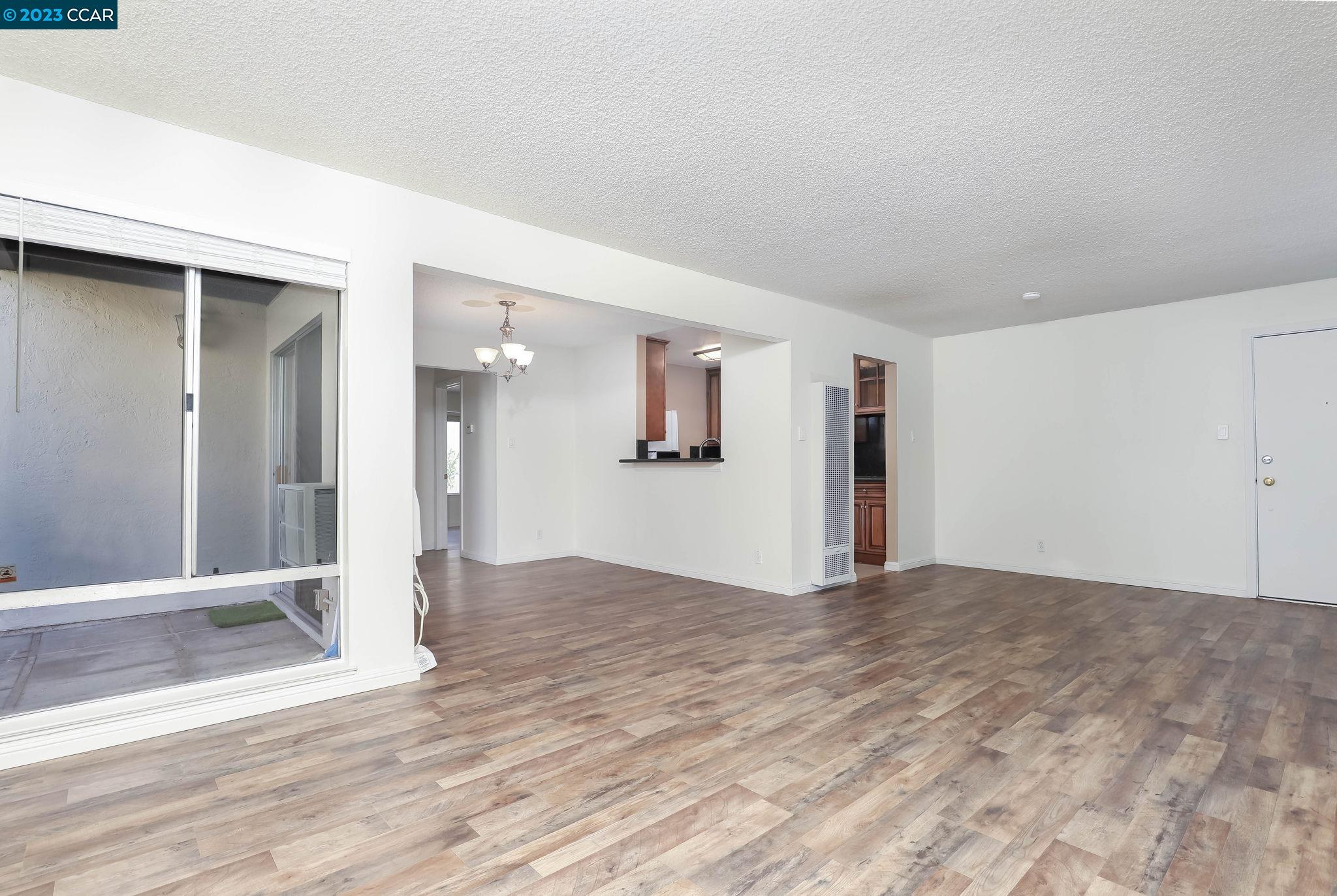 2500 Laguna Circle, Unit C Concord, CA 94520 - Photo 6 of 13 a view of a big room with wooden floor and a kitchen