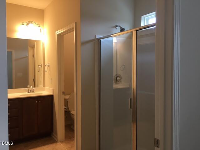 134 Zante Currant Road, Unit 134 Durham, NC 27703 - Photo 9 of 14 a bathroom with a double vanity sink and a mirror