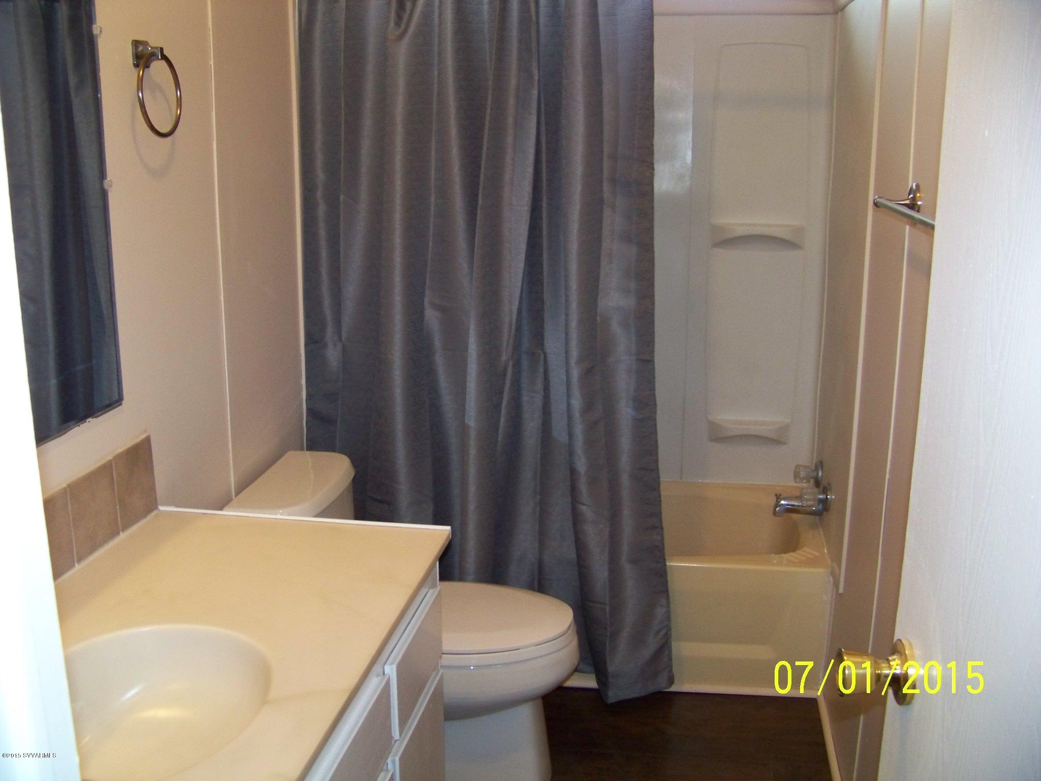 4885 North Gone Fishin Road Rimrock, AZ 86335 - Photo 13 of 17 a bathroom with a sink a toilet and shower curtain