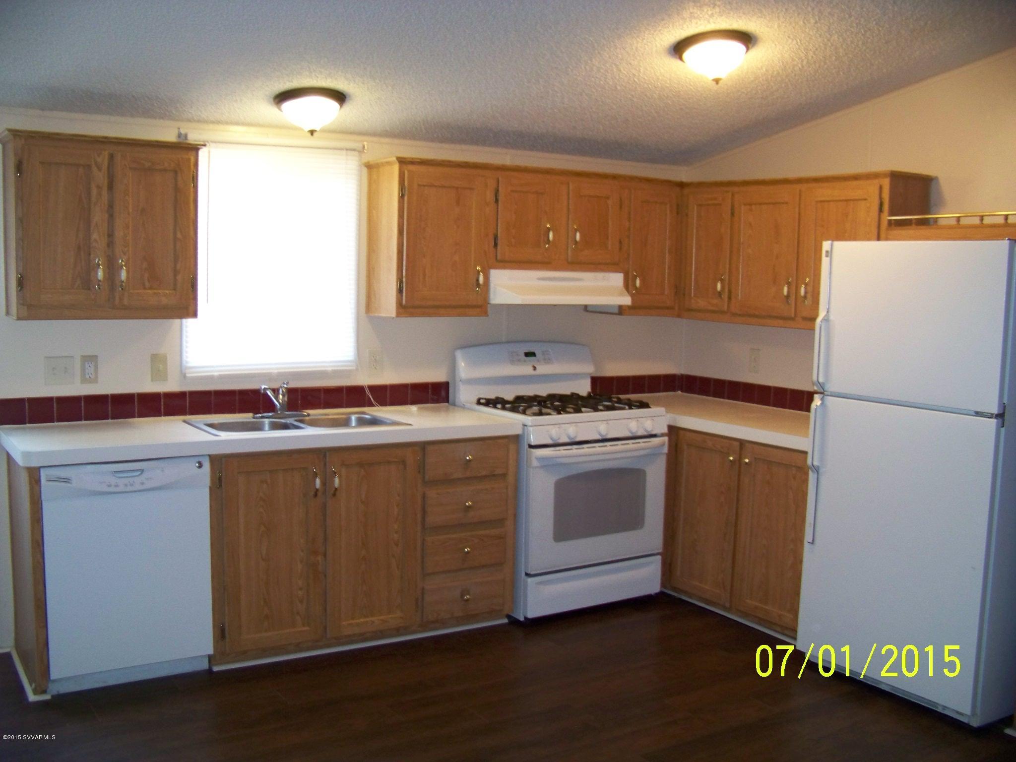 4885 North Gone Fishin Road Rimrock, AZ 86335 - Photo 3 of 17 a kitchen with granite countertop a refrigerator sink and cabinets