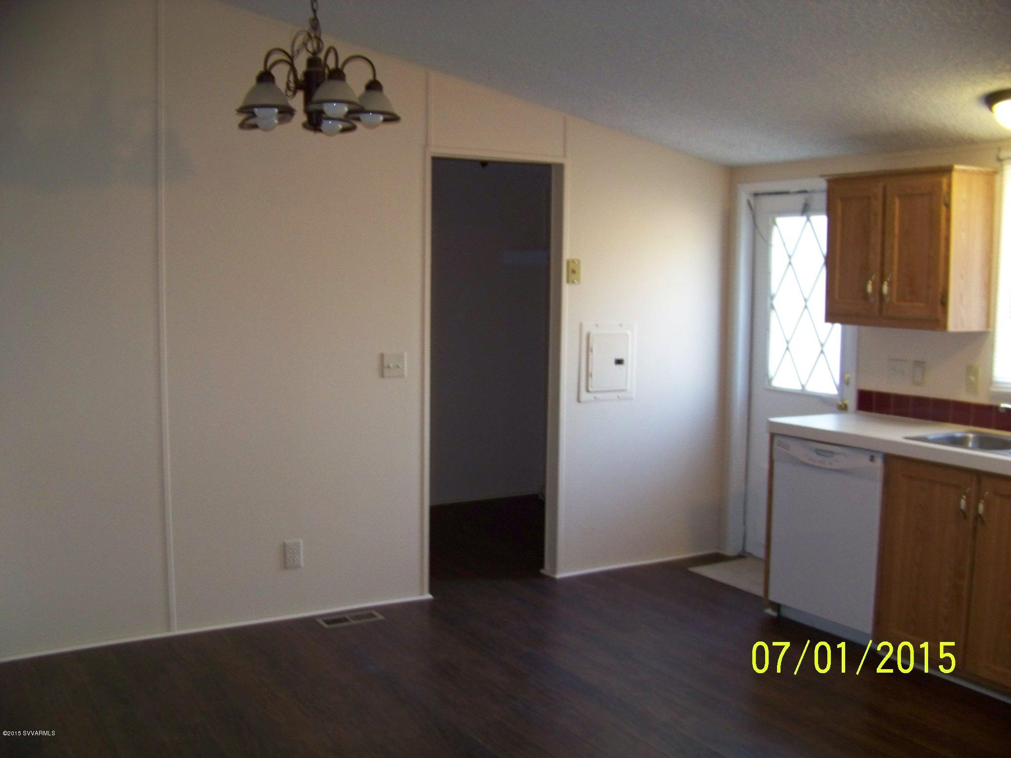 4885 North Gone Fishin Road Rimrock, AZ 86335 - Photo 4 of 17 an empty room with wooden floor cabinet and a window