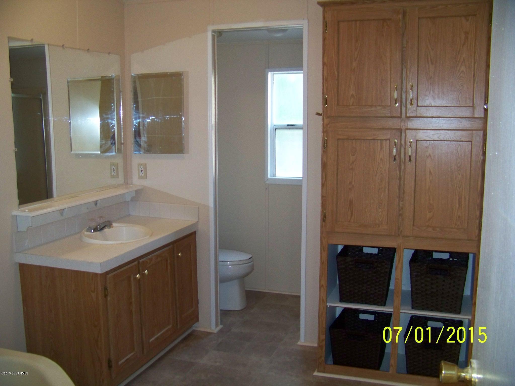 4885 North Gone Fishin Road Rimrock, AZ 86335 - Photo 7 of 17 a bathroom with a sink a toilet and mirror