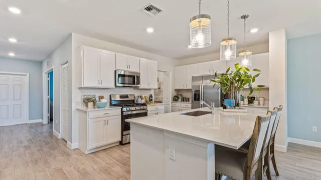 a kitchen with microwave a stove and cabinets