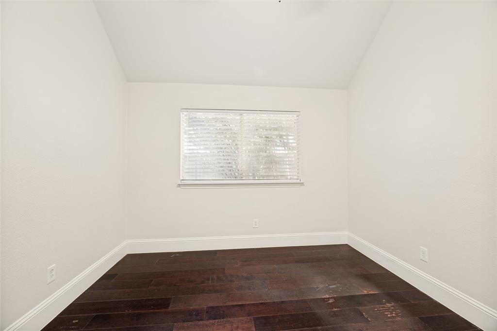 2100 Los Rios Boulevard Plano, TX 75074 - Photo 20 of 25 Spacious room featuring dark wood-finish flooring, white baseboards, and neutral wall tones