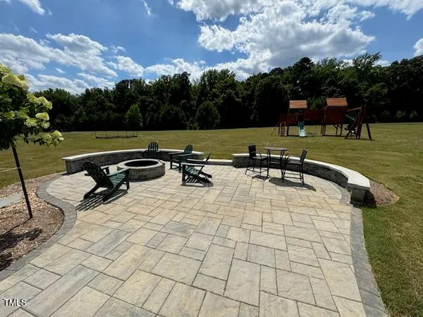 a view of a lake with a bench and trees