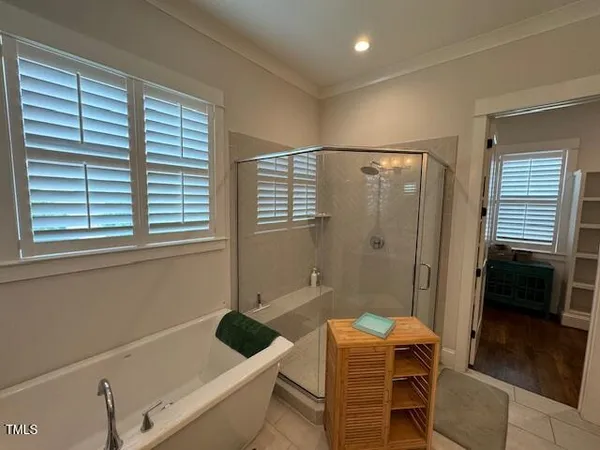 a bathroom with a window and a shower
