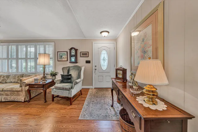 a kitchen with stainless steel appliances granite countertop a refrigerator sink and wooden cabinets