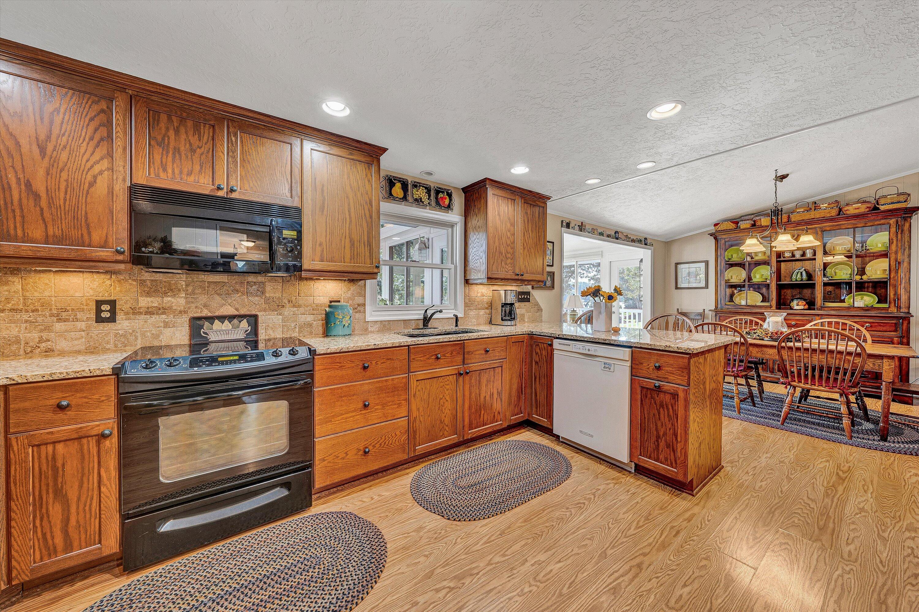 151 Twin Oaks Road Wirtz, VA 24184 - Photo 14 of 41 a kitchen with stainless steel appliances granite countertop a stove sink and cabinets