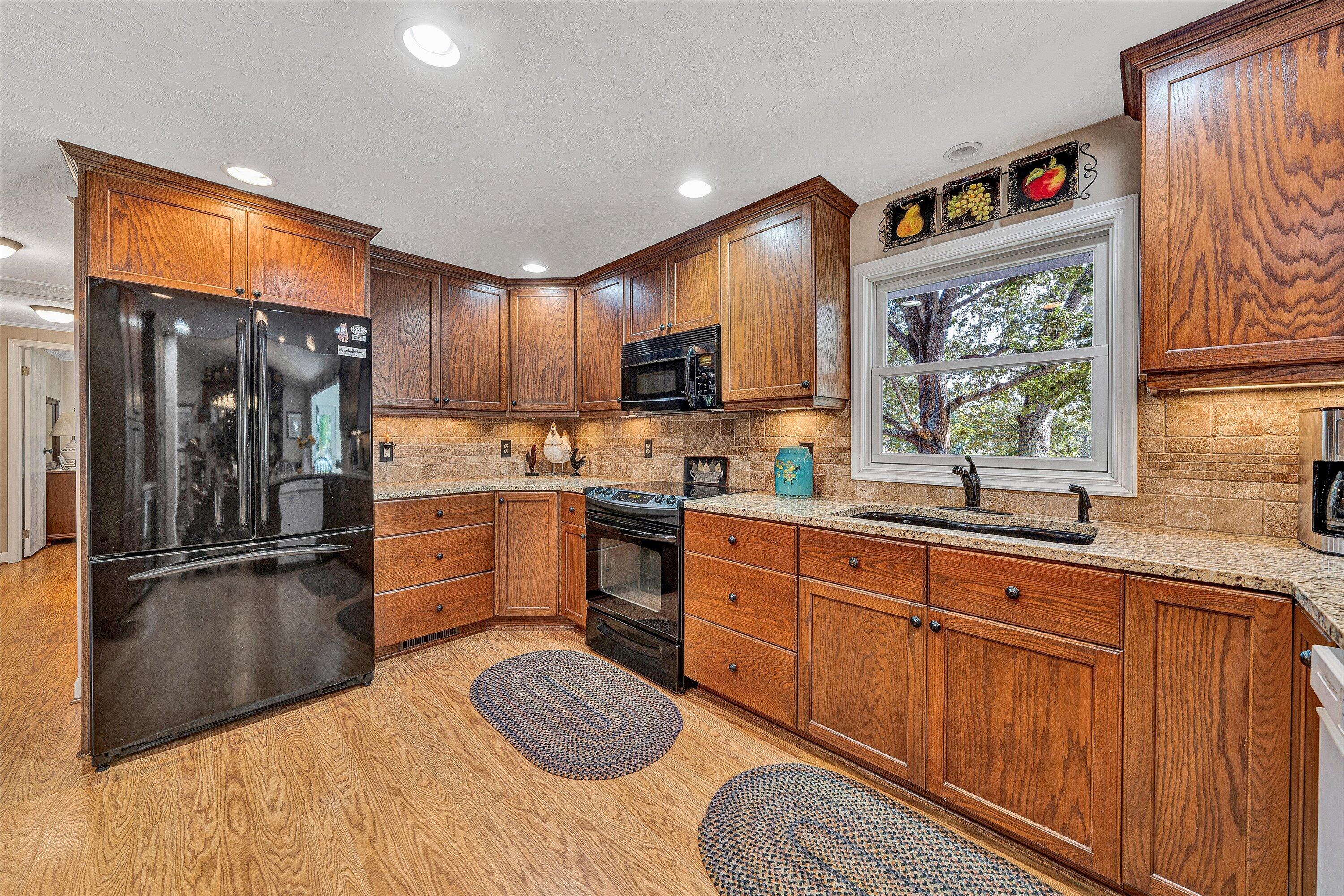 151 Twin Oaks Road Wirtz, VA 24184 - Photo 15 of 41 a kitchen with stainless steel appliances granite countertop a refrigerator sink and wooden cabinets