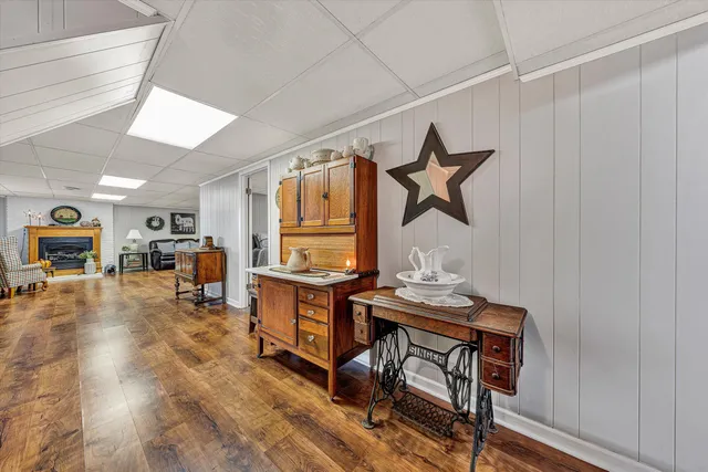 a view of backyard with a table and chairs and a large tree