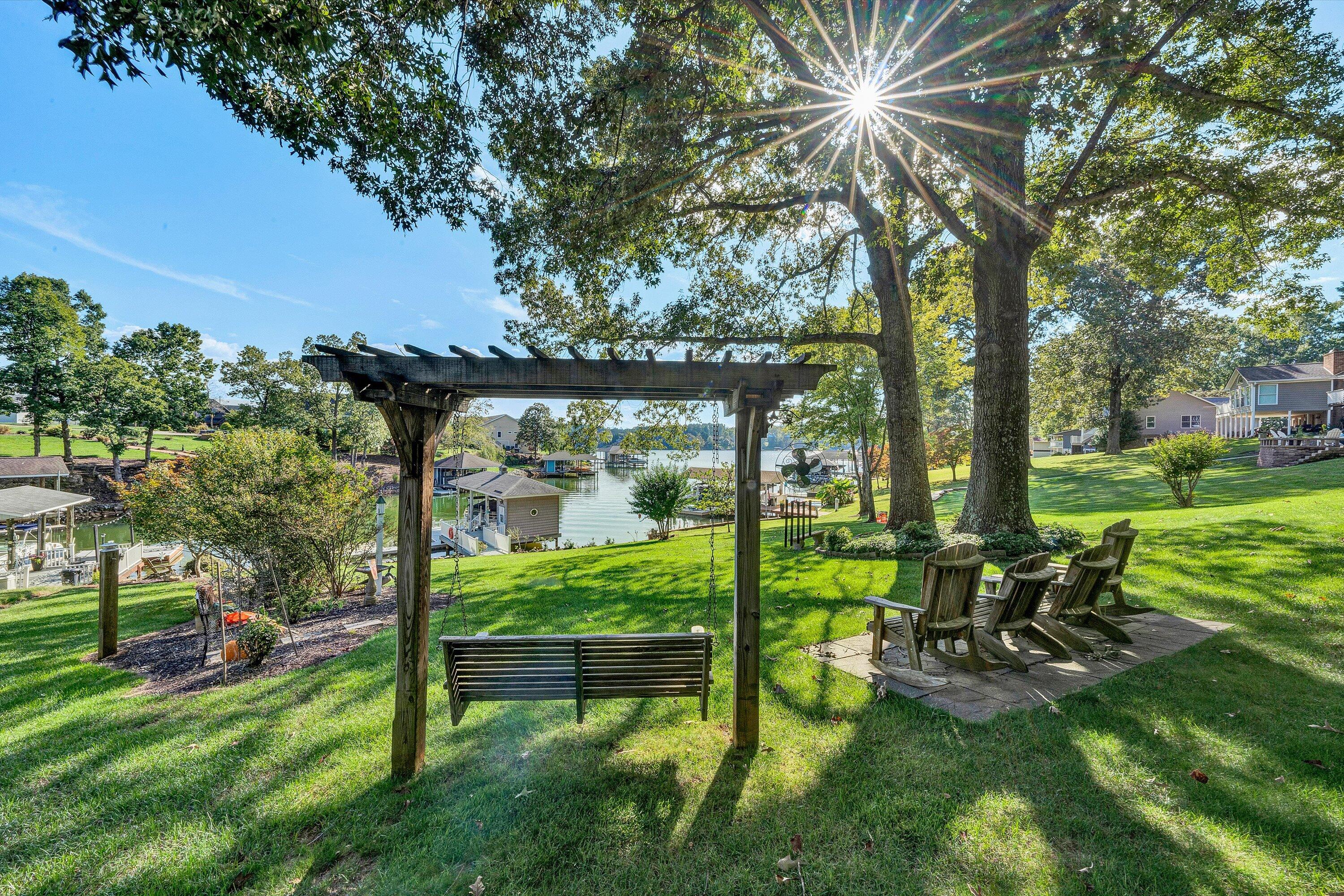 151 Twin Oaks Road Wirtz, VA 24184 - Photo 35 of 41 a view of backyard with a table and chairs and a large tree