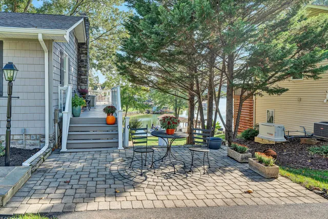 a living room with furniture ceiling fan and a large window