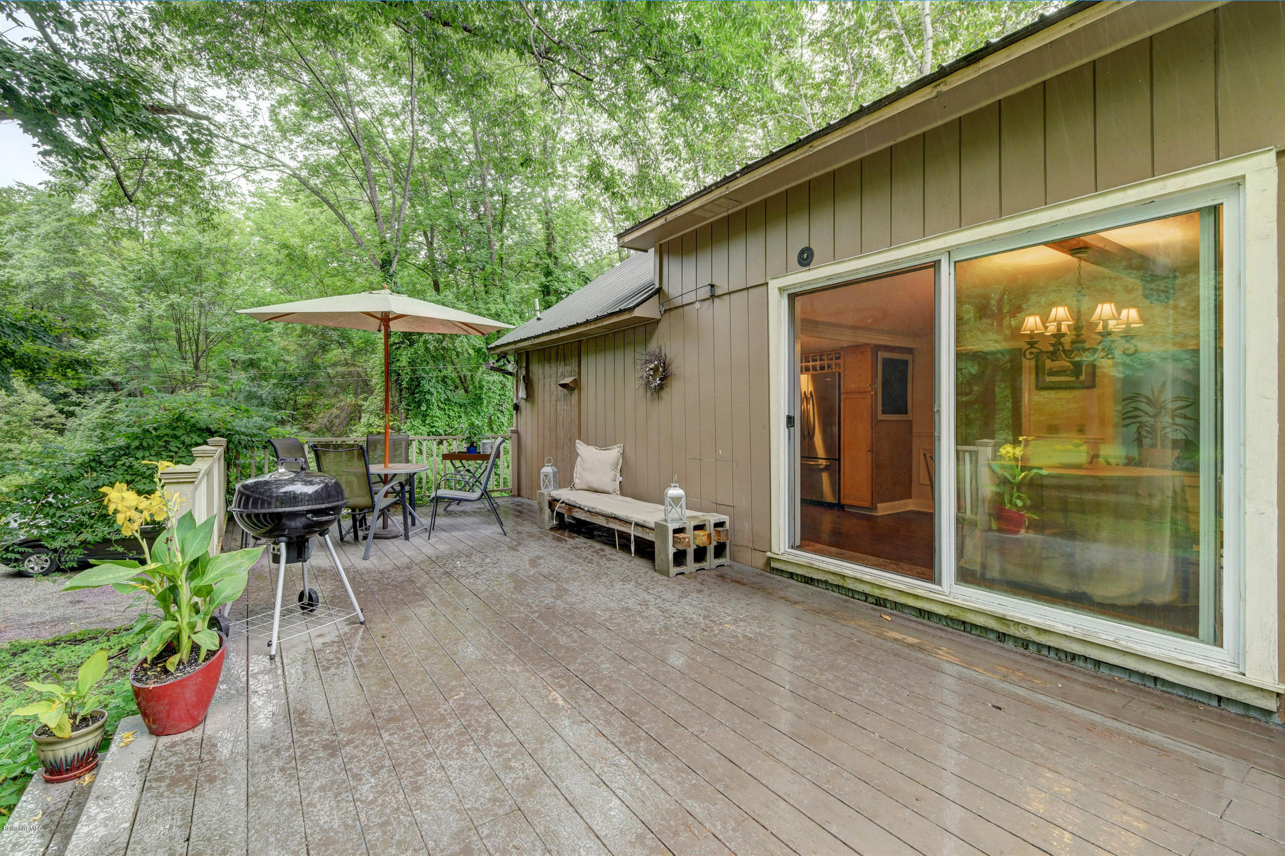 57 State Line Road West Stockbridge, MA 01266 - Photo 18 of 21 a view of a patio with table and chairs under an umbrella