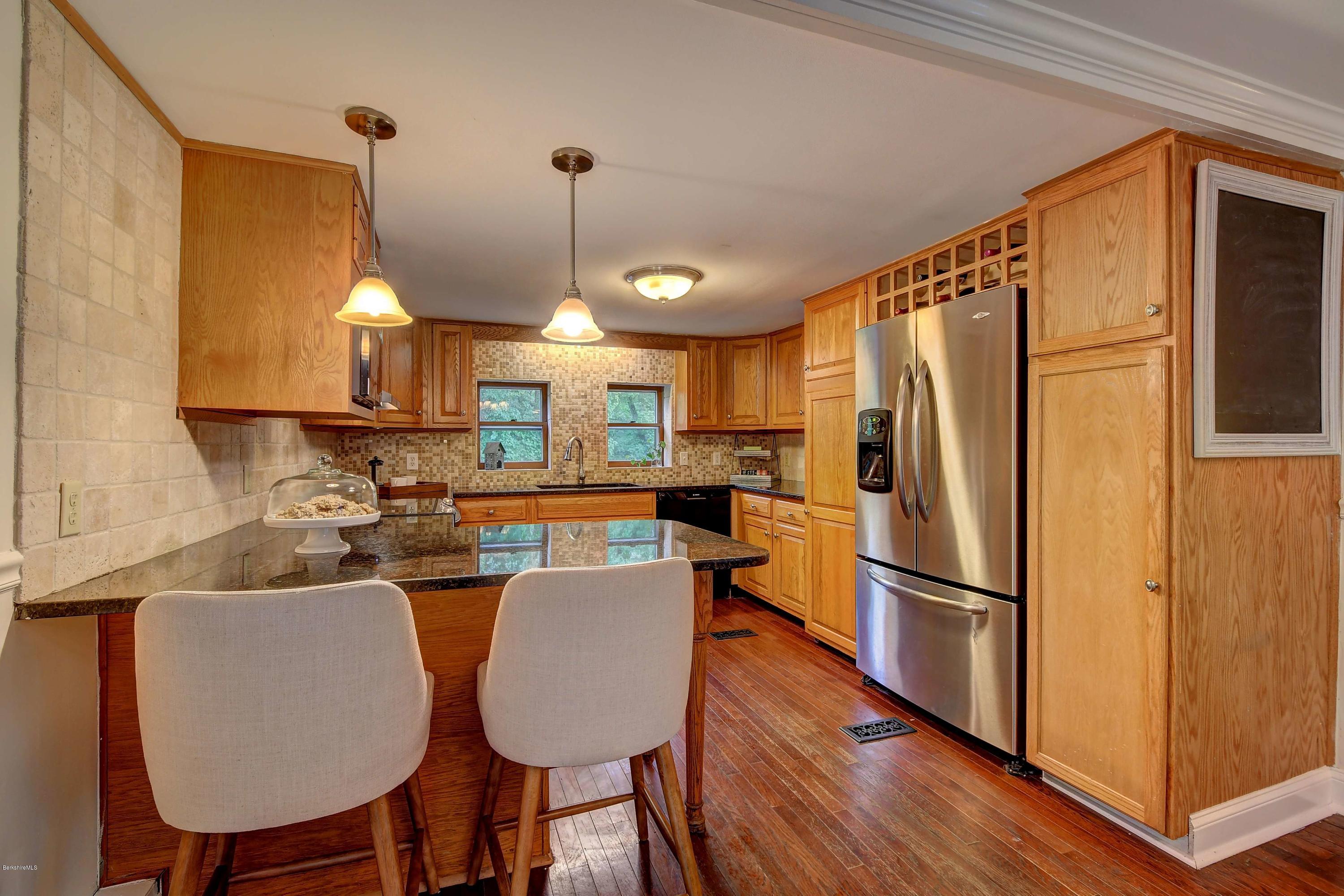 57 State Line Road West Stockbridge, MA 01266 - Photo 7 of 21 a kitchen with stainless steel appliances a refrigerator a sink a dining table and chairs