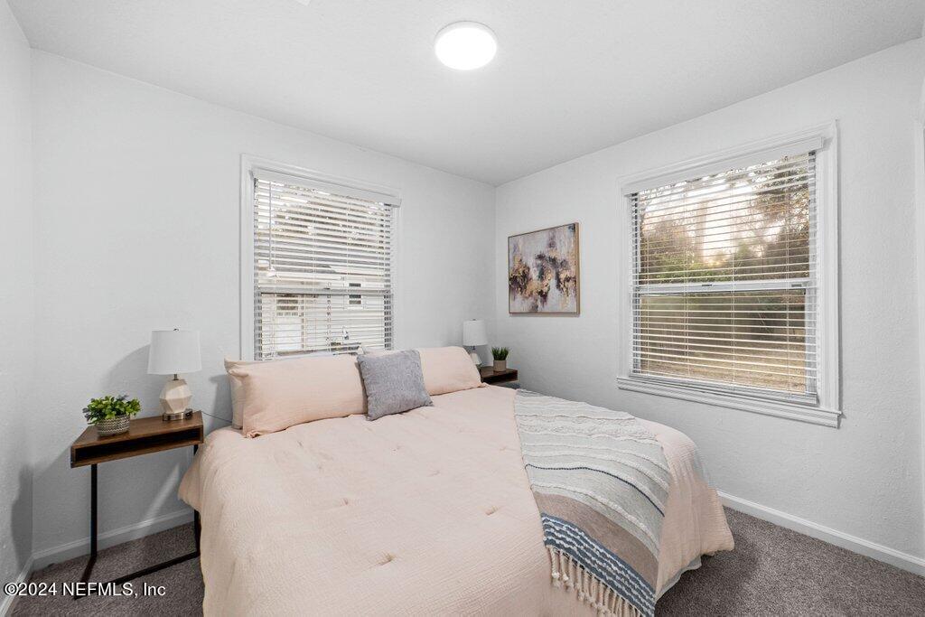 1720 Lilly Road East Jacksonville, FL 32207 - Photo 16 of 33 a bedroom with a bed and window