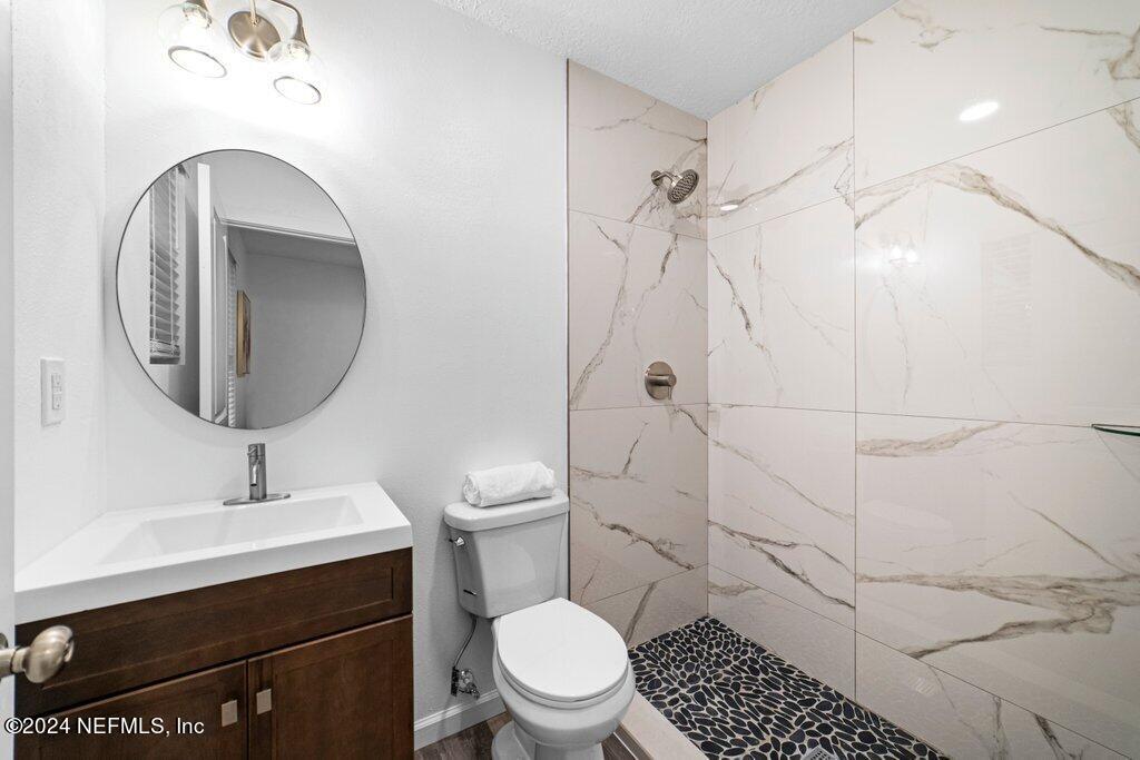 1720 Lilly Road East Jacksonville, FL 32207 - Photo 19 of 33 a bathroom with a sink toilet and shower