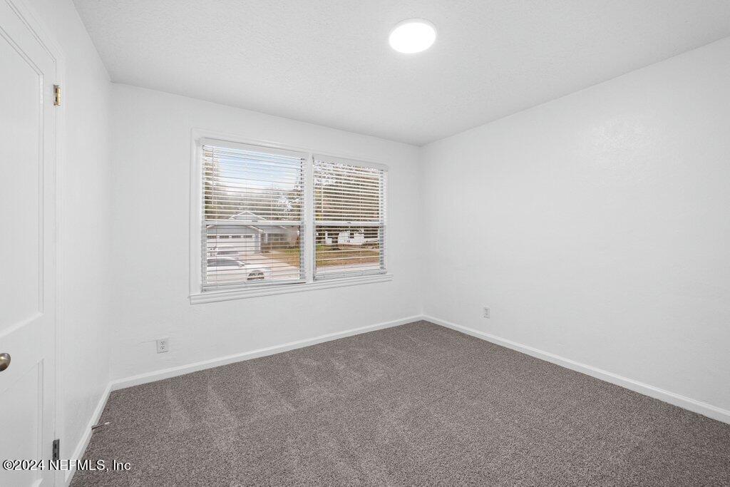1720 Lilly Road East Jacksonville, FL 32207 - Photo 23 of 33 an empty room with a window