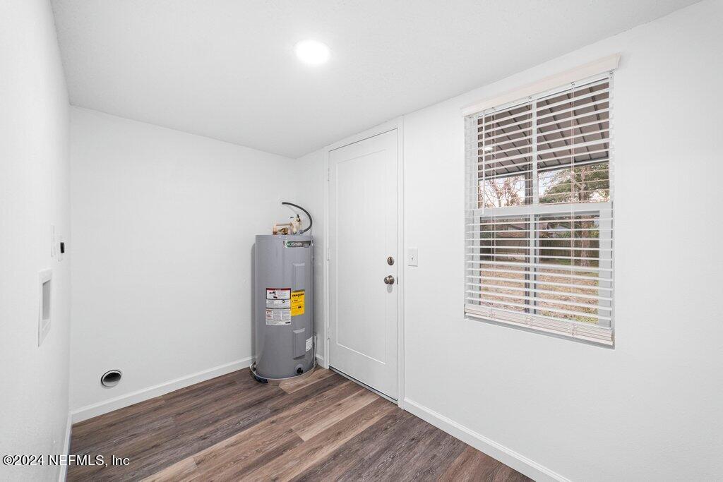 1720 Lilly Road East Jacksonville, FL 32207 - Photo 25 of 33 a view of an empty room with wooden floor and a window