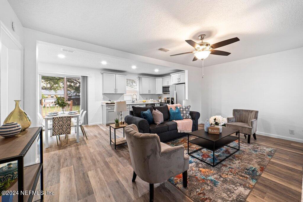 1720 Lilly Road East Jacksonville, FL 32207 - Photo 3 of 33 a living room with furniture and a wooden floor