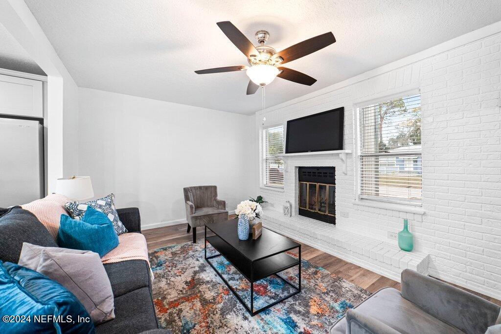 1720 Lilly Road East Jacksonville, FL 32207 - Photo 6 of 33 a living room with furniture a flat screen tv and a fireplace