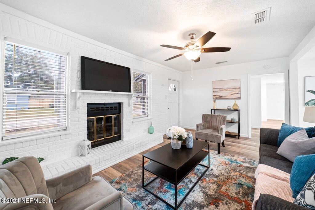 1720 Lilly Road East Jacksonville, FL 32207 - Photo 7 of 33 a living room with furniture a fireplace and a flat screen tv