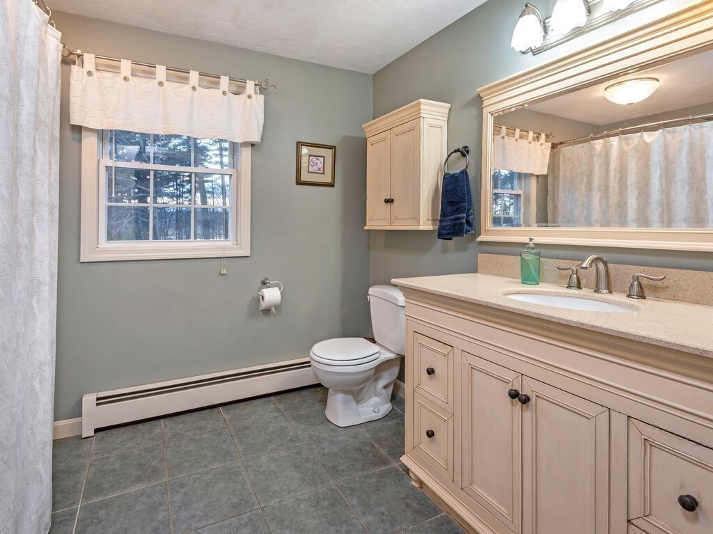 86 Mason Road Townsend, MA 01474 - Photo 29 of 41 a bathroom with a granite countertop sink a toilet and a mirror